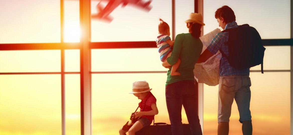 Happy family with suitcases in the airport.