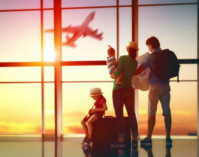 Happy family with suitcases in the airport.